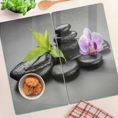 Sklenená doska na krájanie Kamene a orchidea na pozadí