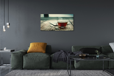 Obraz canvas Ohrievať lyžičku čaju