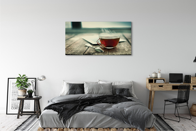 Obraz canvas Ohrievať lyžičku čaju