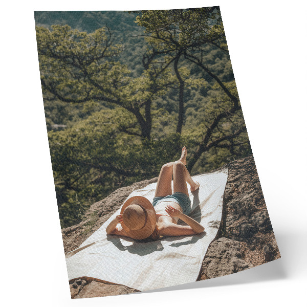 Plagát do obývačky Relax na skale, zelené stromy, klobúk, príroda